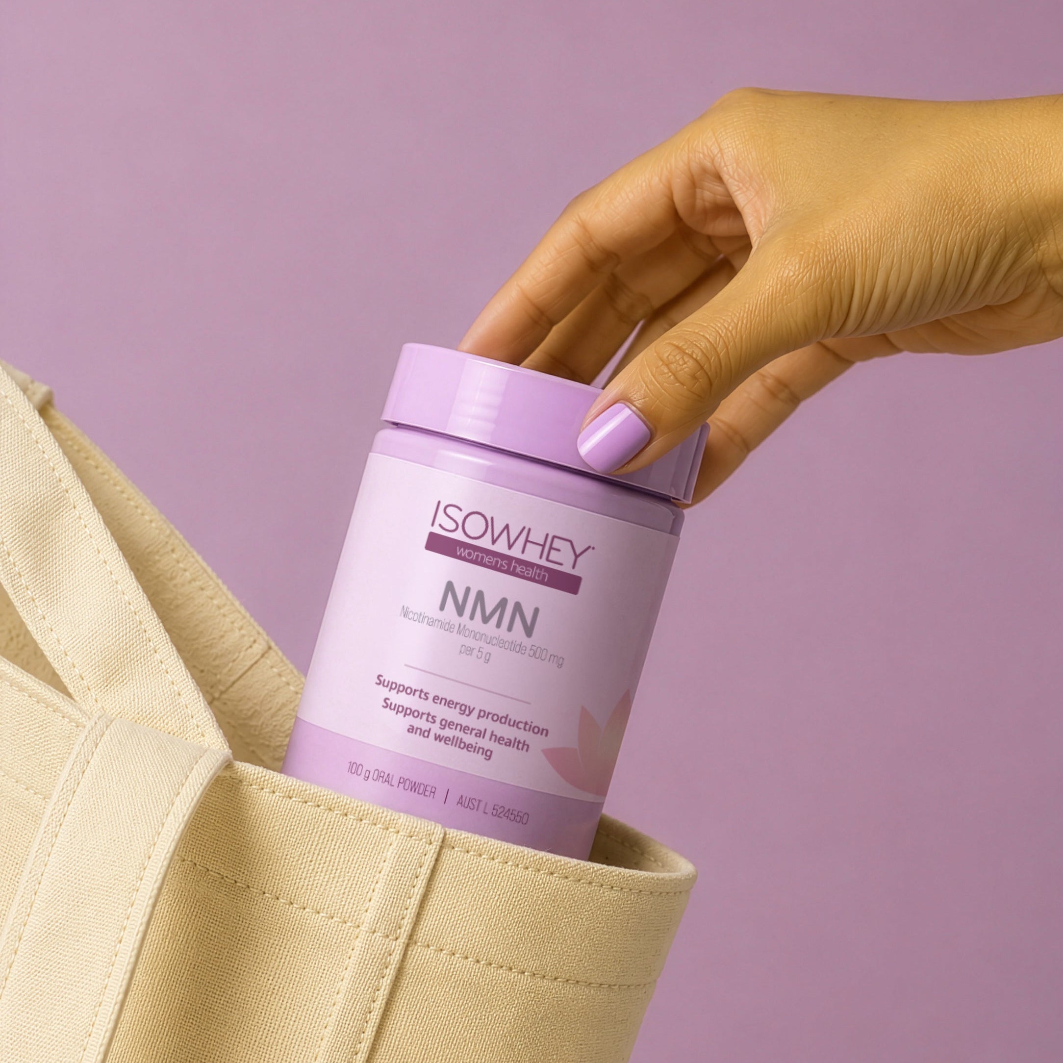 Hand holding a purple container labeled 'ISOWHEY NMN' against a light purple background