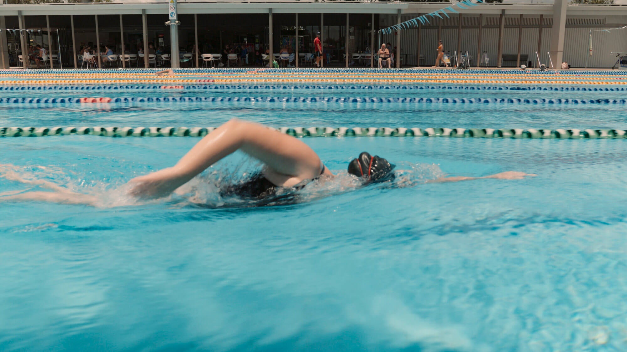 Alicia swimming in an Olympic-size swimming pool