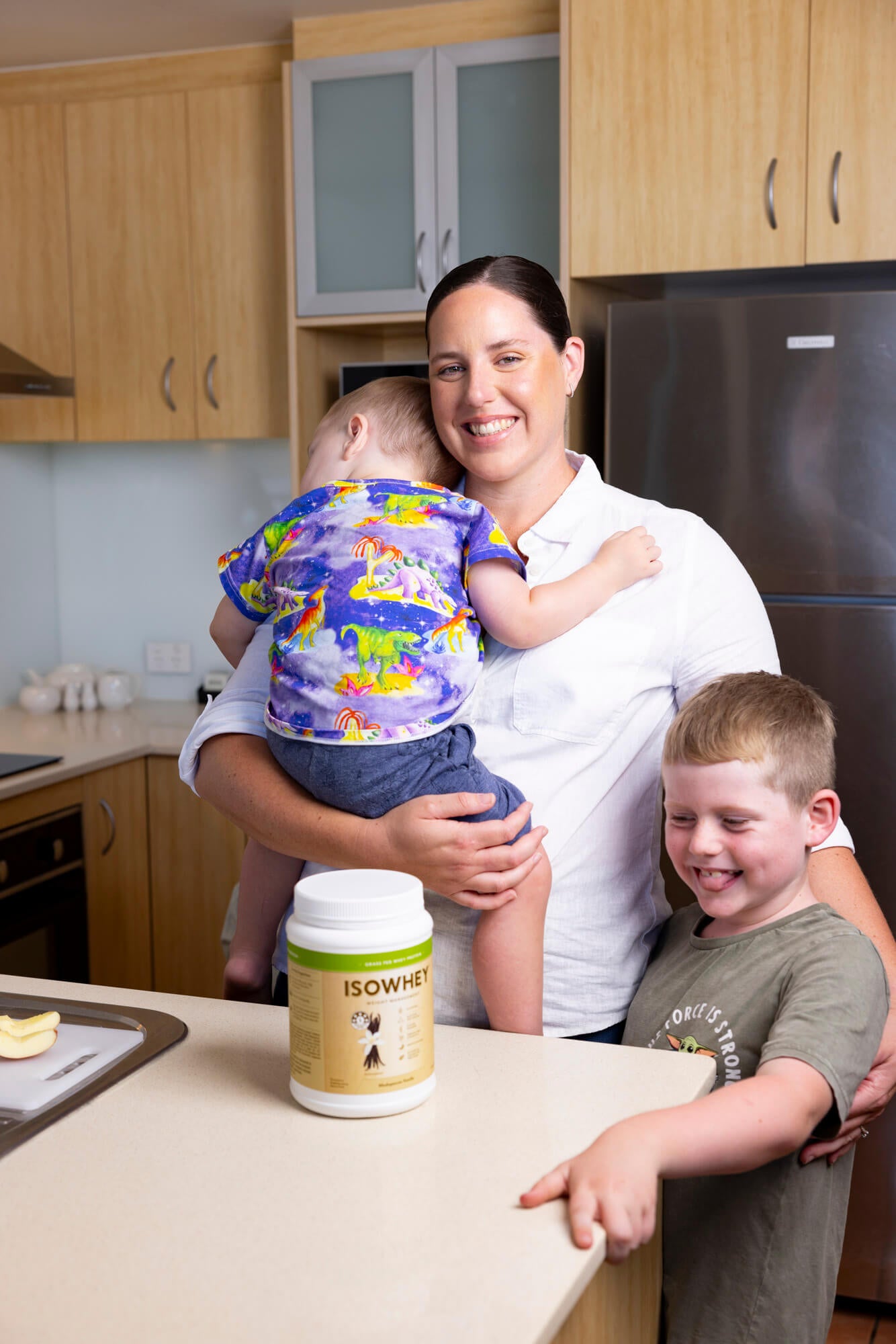 Alicia with her two children and an IsoWhey Complete Madagascan Vanilla Shake atop the counter