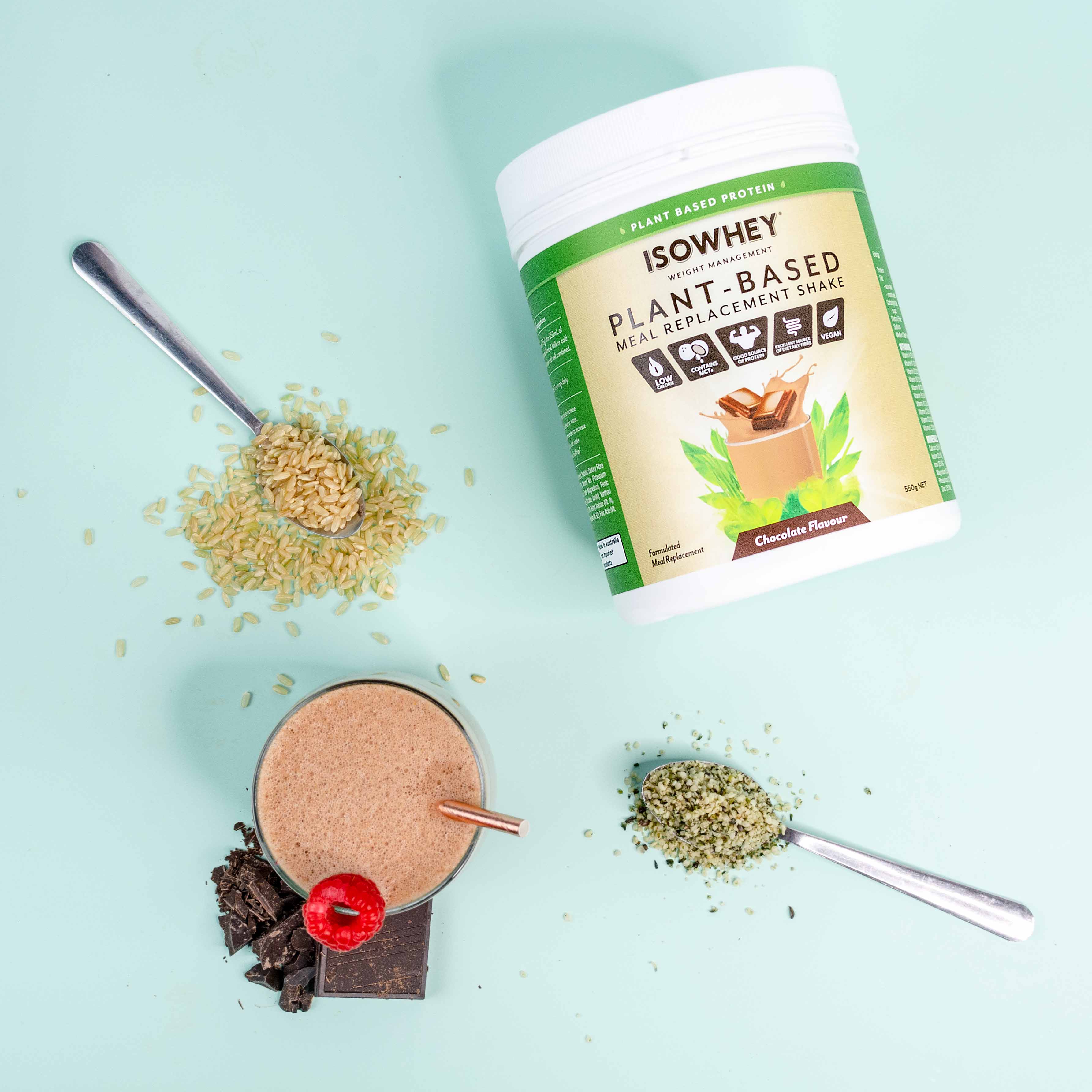 An overhead shot of IsoWhey Plant-Based Meal Replacement Chocolate Shake 550g witth a prepared cup and some ingredients