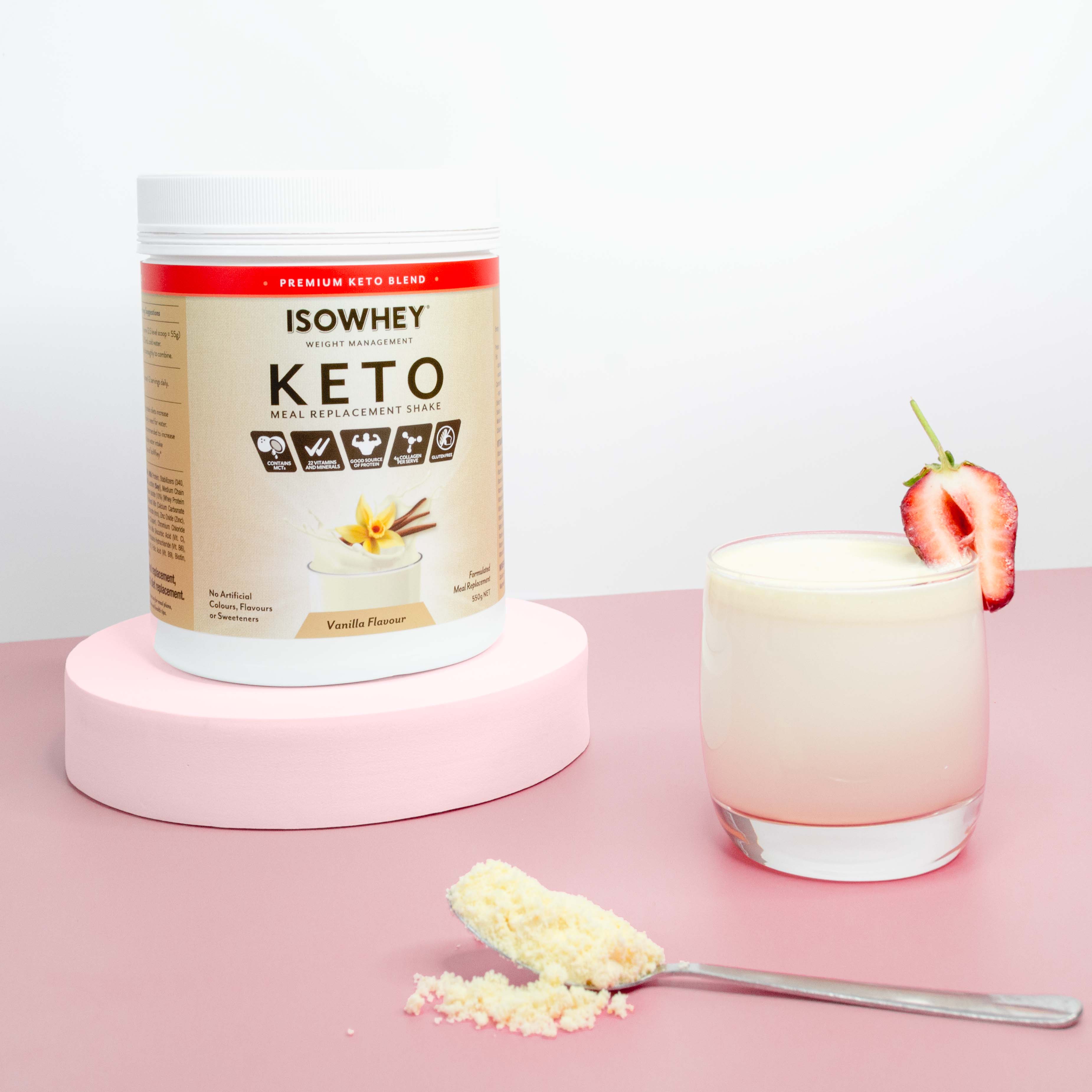 IsoWhey Vanilla Keto Meal Replacement Shake 550g pack with ready-to-drink glass and spoonful shake power on a pink floor.